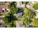 An aerial view features the home's dark roof, manicured lawns, and beautiful, mature landscaping at 1173 Valley Creek Run, Winter Park, FL 32792