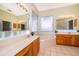 Bright bathroom features a garden tub, double vanities, and tiled floors at 1173 Valley Creek Run, Winter Park, FL 32792