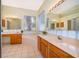 Bright bathroom features a garden tub, double vanities, and a large window for natural light at 1173 Valley Creek Run, Winter Park, FL 32792