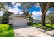 Charming single-Gathering home featuring a two-car garage, lush lawn, and mature trees offering shade at 1173 Valley Creek Run, Winter Park, FL 32792