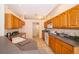 Well-lit kitchen features wooden cabinets, tiled floors, and modern appliances at 1173 Valley Creek Run, Winter Park, FL 32792