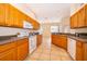 The spacious kitchen has wooden cabinets, tiled floors, and stainless steel appliances at 1173 Valley Creek Run, Winter Park, FL 32792