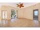 Bright living room with tile floors and a sliding glass door leading to the patio area at 1173 Valley Creek Run, Winter Park, FL 32792