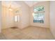 Inviting living room featuring tile flooring, natural light, and an elegant light fixture at 1173 Valley Creek Run, Winter Park, FL 32792