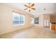 Spacious living room featuring tile flooring, a ceiling fan, and natural light from several windows at 1173 Valley Creek Run, Winter Park, FL 32792