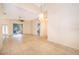 Open-concept living room with tile flooring, ceiling fan, and access to the outdoor patio at 1173 Valley Creek Run, Winter Park, FL 32792
