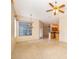 Open-concept living room featuring tile flooring and views of the kitchen and outdoor patio at 1173 Valley Creek Run, Winter Park, FL 32792