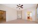 Large main bedroom featuring neutral carpeting and access to both the bathroom and outdoor patio at 1173 Valley Creek Run, Winter Park, FL 32792