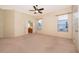 Spacious main bedroom features neutral carpeting, a ceiling fan, and a bathroom entrance at 1173 Valley Creek Run, Winter Park, FL 32792