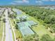 Aerial view of the community basketball and tennis courts, near a pond at 1191 Honey Blossom Dr # D, Orlando, FL 32824
