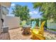 Inviting backyard patio offers a charming space with colorful Adirondack chairs and a fire pit at 1191 Honey Blossom Dr # D, Orlando, FL 32824