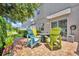 Relaxing backyard patio offers colorful Adirondack chairs and a cozy fire pit for outdoor enjoyment at 1191 Honey Blossom Dr # D, Orlando, FL 32824