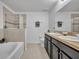 Bright bathroom featuring double vanity, soaking tub, and glass-enclosed shower at 1191 Honey Blossom Dr # D, Orlando, FL 32824