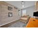 Cozy room features unique wood wall, comfy armchair, and natural light at 1191 Honey Blossom Dr # D, Orlando, FL 32824