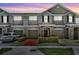 Charming townhome with a well-manicured lawn and inviting front entrance and single car garages at 1191 Honey Blossom Dr # D, Orlando, FL 32824