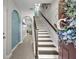 Bright foyer with beautiful staircase, arched doorway, and lovely decorations at 1191 Honey Blossom Dr # D, Orlando, FL 32824