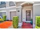 Inviting front entry showcasing a lovely wreath, brick paved entry and meticulous landscaping at 1191 Honey Blossom Dr # D, Orlando, FL 32824