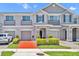 Charming townhome with well-maintained landscaping, a brick driveway, and a one-car garage at 1191 Honey Blossom Dr # D, Orlando, FL 32824