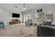 Bright living room boasts contemporary furnishings, modern ceiling fan and wainscoting detail at 1191 Honey Blossom Dr # D, Orlando, FL 32824