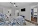 Spacious main bedroom includes a ceiling fan, television, ensuite bath and walk-in closet access at 1191 Honey Blossom Dr # D, Orlando, FL 32824