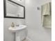 Stylish powder room features a pedestal sink, decorative mirror and neutral tones at 1191 Honey Blossom Dr # D, Orlando, FL 32824