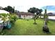 Lush green backyard with small trees and bushes planted throughout at 12207 Florida Woods Ln, Orlando, FL 32824
