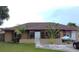 Cozy one-story home with tropical landscaping and a convenient driveway at 12207 Florida Woods Ln, Orlando, FL 32824