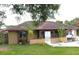 Charming one-story home with a well-manicured lawn and a welcoming entrance at 12207 Florida Woods Ln, Orlando, FL 32824
