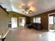 Inviting living area with tile floors, a ceiling fan, and a comfortable seating area at 12207 Florida Woods Ln, Orlando, FL 32824