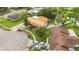 Overhead view of the house showing the yard, cars in the driveway, and green space at 14157 Louisville Ct, Orlando, FL 32826