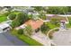 Aerial view of a house with a brick driveway, lush landscaping, a shed, and a fenced yard at 14157 Louisville Ct, Orlando, FL 32826