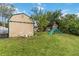 View of backyard with shed and play set at 14157 Louisville Ct, Orlando, FL 32826