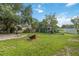 Backyard with brick patio and mature tree, and play set at 14157 Louisville Ct, Orlando, FL 32826