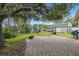 Backyard with brick patio and mature tree, and play set at 14157 Louisville Ct, Orlando, FL 32826