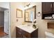 Well-lit bathroom boasts a granite-topped vanity and decorative wall accents at 14157 Louisville Ct, Orlando, FL 32826