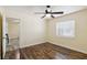 Inviting bedroom features hardwood-style flooring and a bright, airy atmosphere at 14157 Louisville Ct, Orlando, FL 32826