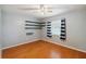 Light-filled bedroom features hardwood floors, a ceiling fan, and unique shelving at 14157 Louisville Ct, Orlando, FL 32826