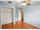 Cozy bedroom with blue walls, hardwood floors, a walk-in closet, and neutral accents at 14157 Louisville Ct, Orlando, FL 32826