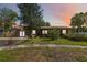 Charming home with a metal roof and beautiful landscaping at 14157 Louisville Ct, Orlando, FL 32826