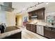 Updated kitchen features stainless steel appliances, tile backsplash, and light countertops at 14157 Louisville Ct, Orlando, FL 32826