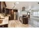 Open kitchen featuring stainless steel appliances, dark wood cabinets, and a modern vent hood at 14157 Louisville Ct, Orlando, FL 32826