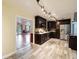 Open kitchen with dark wood cabinets and stainless steel appliances, connects to the living room at 14157 Louisville Ct, Orlando, FL 32826
