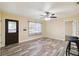 Bright living room with wood-look floors and a decorative ceiling fan at 14157 Louisville Ct, Orlando, FL 32826