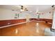 Spacious living room with two ceiling fans, wainscotting and a view into the updated kitchen at 14157 Louisville Ct, Orlando, FL 32826