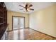 Comfortable living room boasts decorative ceiling fan and built-in shelving at 14157 Louisville Ct, Orlando, FL 32826
