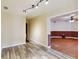 Living room featuring light-colored walls, wood-look flooring, and seamless transition to the next room at 14157 Louisville Ct, Orlando, FL 32826