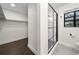 Modern bathroom featuring a glass-enclosed shower, white walls, and a sleek black-trimmed window at 1523 N Beach St, Ormond Beach, FL 32174