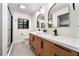 Modern bathroom with double sinks, sleek fixtures, a glass-enclosed shower, and stylish mirrors at 1523 N Beach St, Ormond Beach, FL 32174