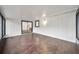 Bright bonus room with hardwood floors, white paneled walls and large sliders at 1523 N Beach St, Ormond Beach, FL 32174