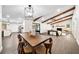Spacious open-concept living area with wood beams, fireplace, dining, and modern lighting at 1523 N Beach St, Ormond Beach, FL 32174